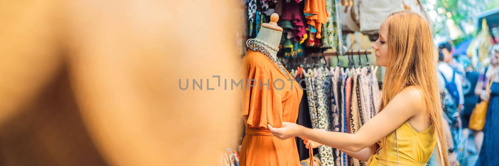 Woman traveler choose souvenirs in the market at Ubud in Bali, Indonesia. BANNER, LONG FORMAT