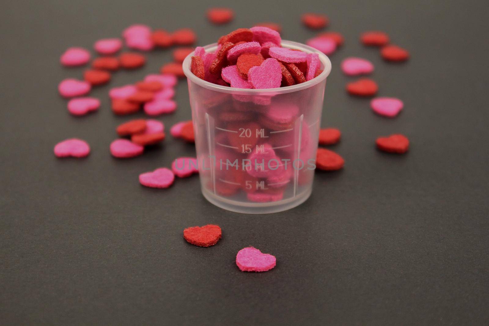 Red Pink Heart Candy in Transparent Cup Dark Background Love Valentine Concept.