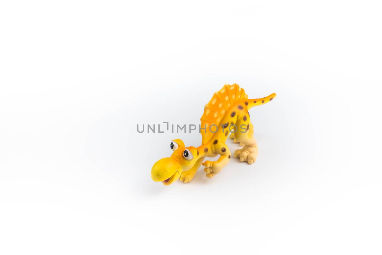 A beautiful funny dinosaur plastic toy isolated on white background by JuliaDorian