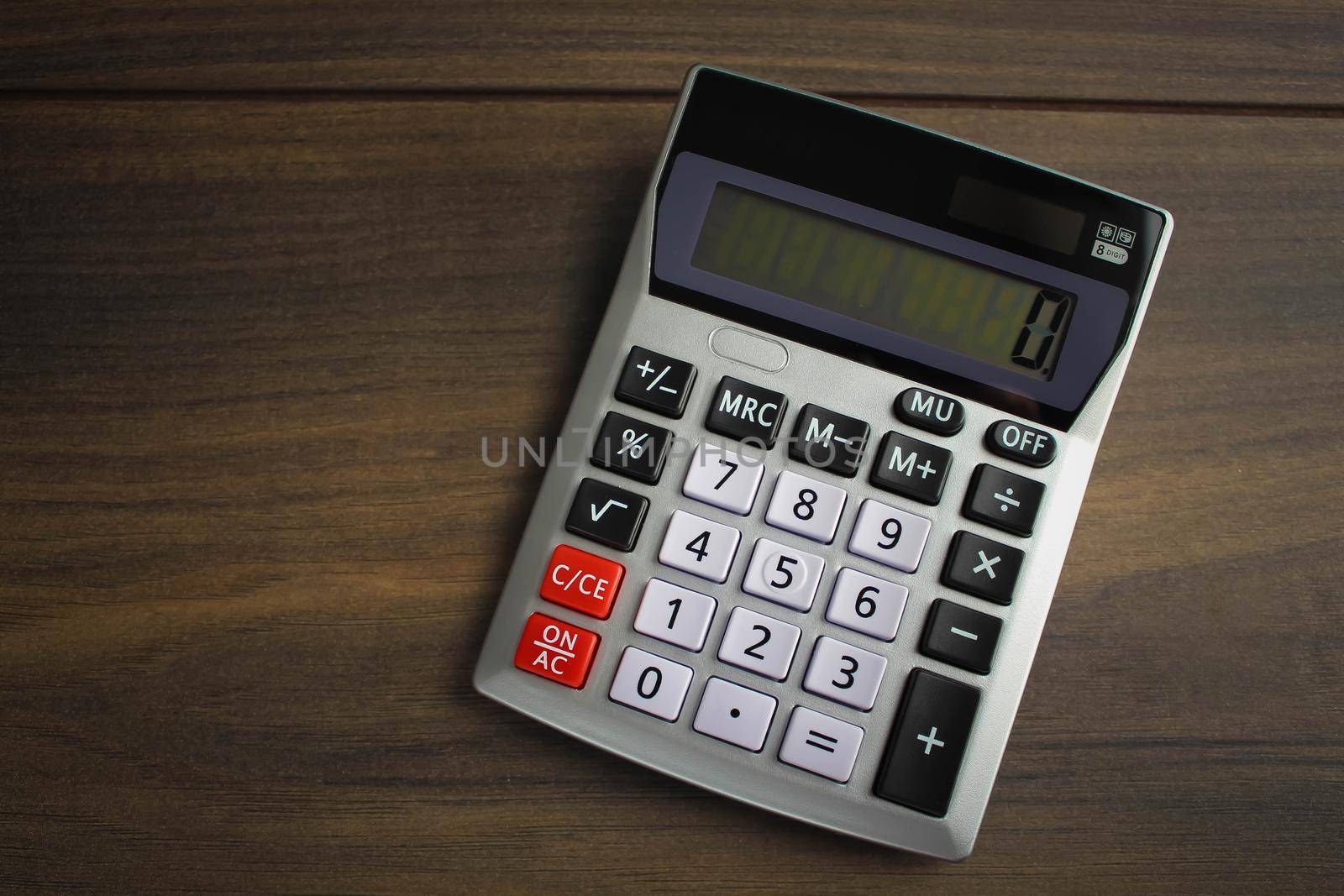 Top view photo of workplace with calculator on notebook on isolated wooden table background with copyspace. Business, coins, bitcoin concept