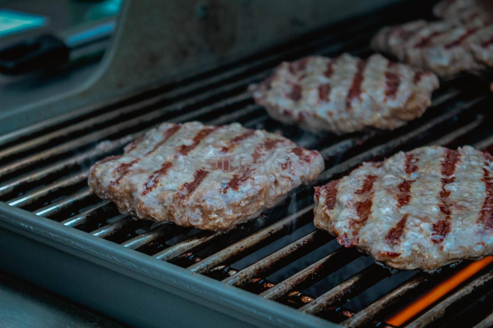 Smoky hamburger meat grilling for burgers. BBQ Grilled Burgers Patties.