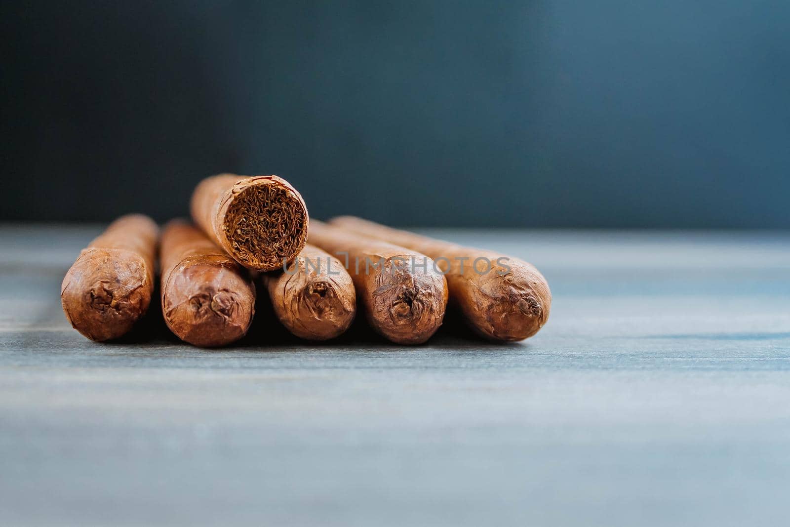 Close view of cigars on the wooden background