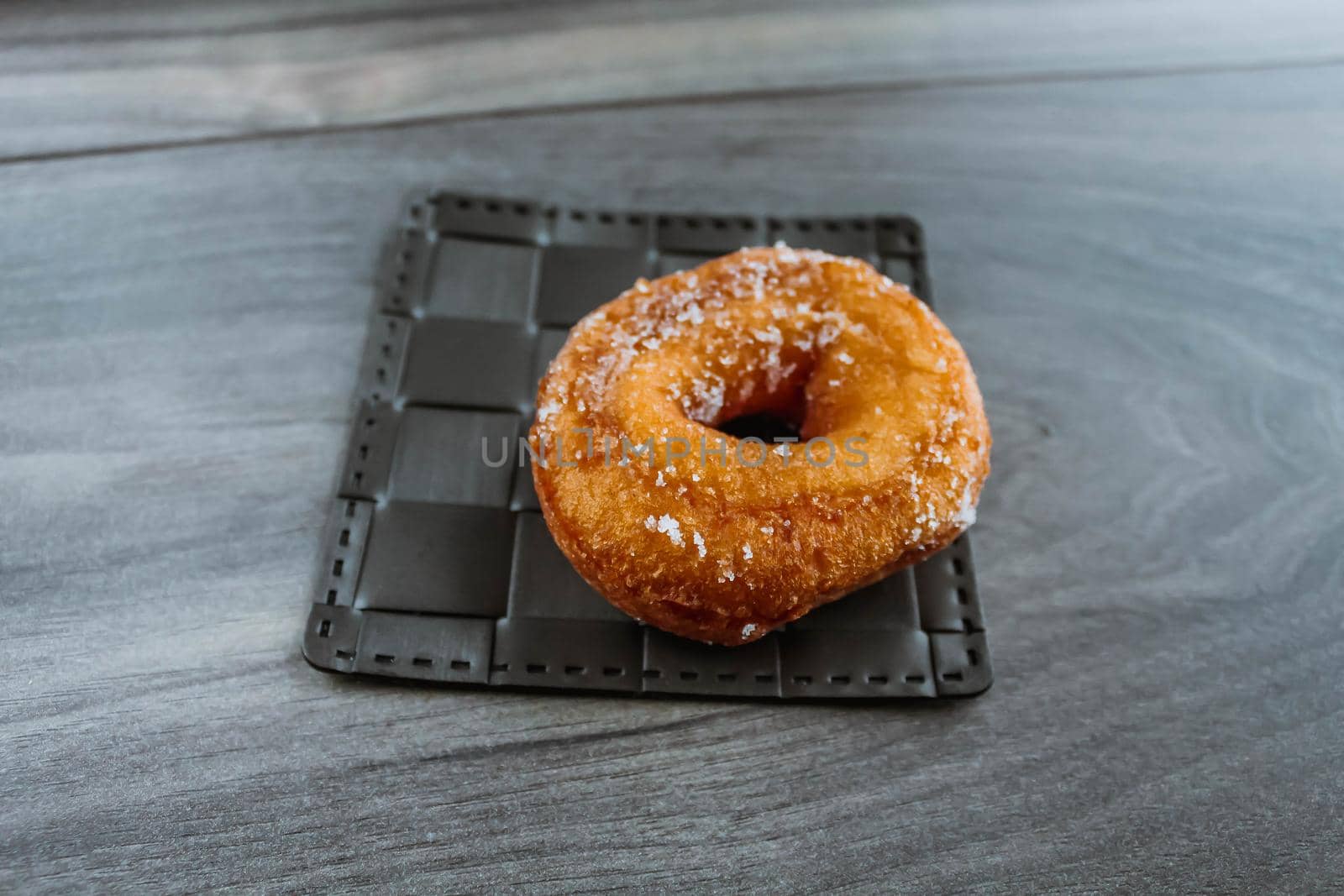 Sugar donut on a wooden background