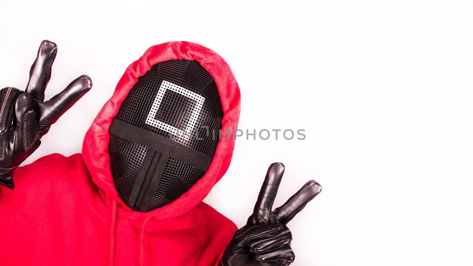 Squid Game red guard with piece sign hands on white background. Space for text. Pink Guard from Squid Game of new Netflix show. South Korean tv series. Gatineau, Quebec Canada - November 2, 2021