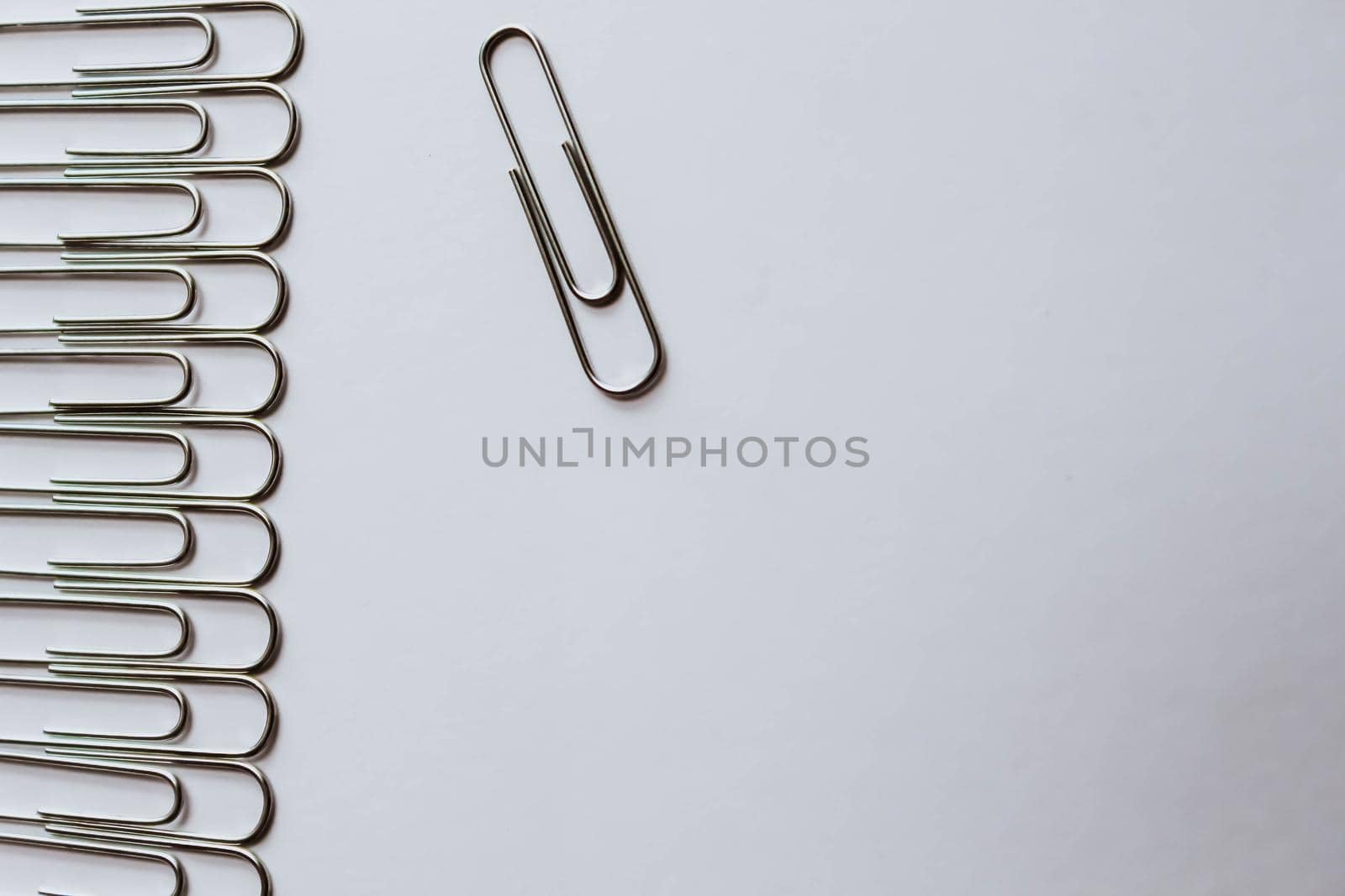 Metal paper clips on white background. Business concept by JuliaDorian