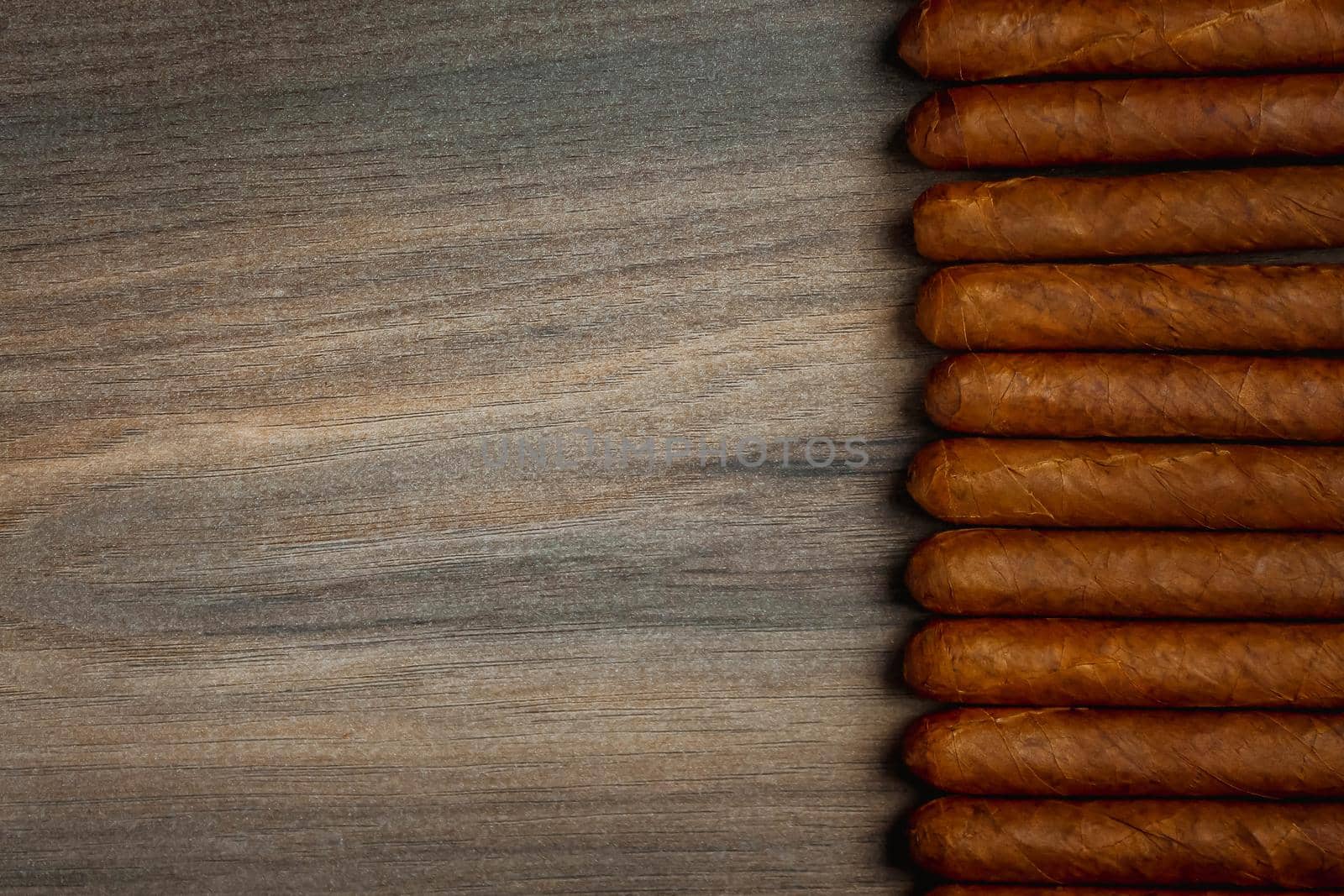 Close view of cigars on the wooden background by JuliaDorian