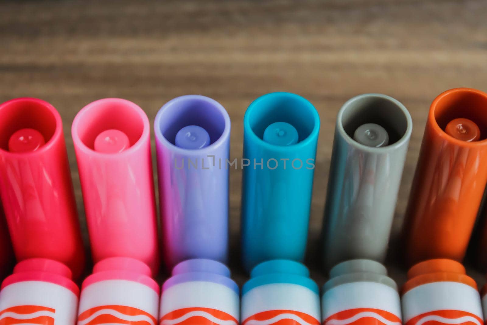 Colorful rainbow markers caps with blurred background by JuliaDorian