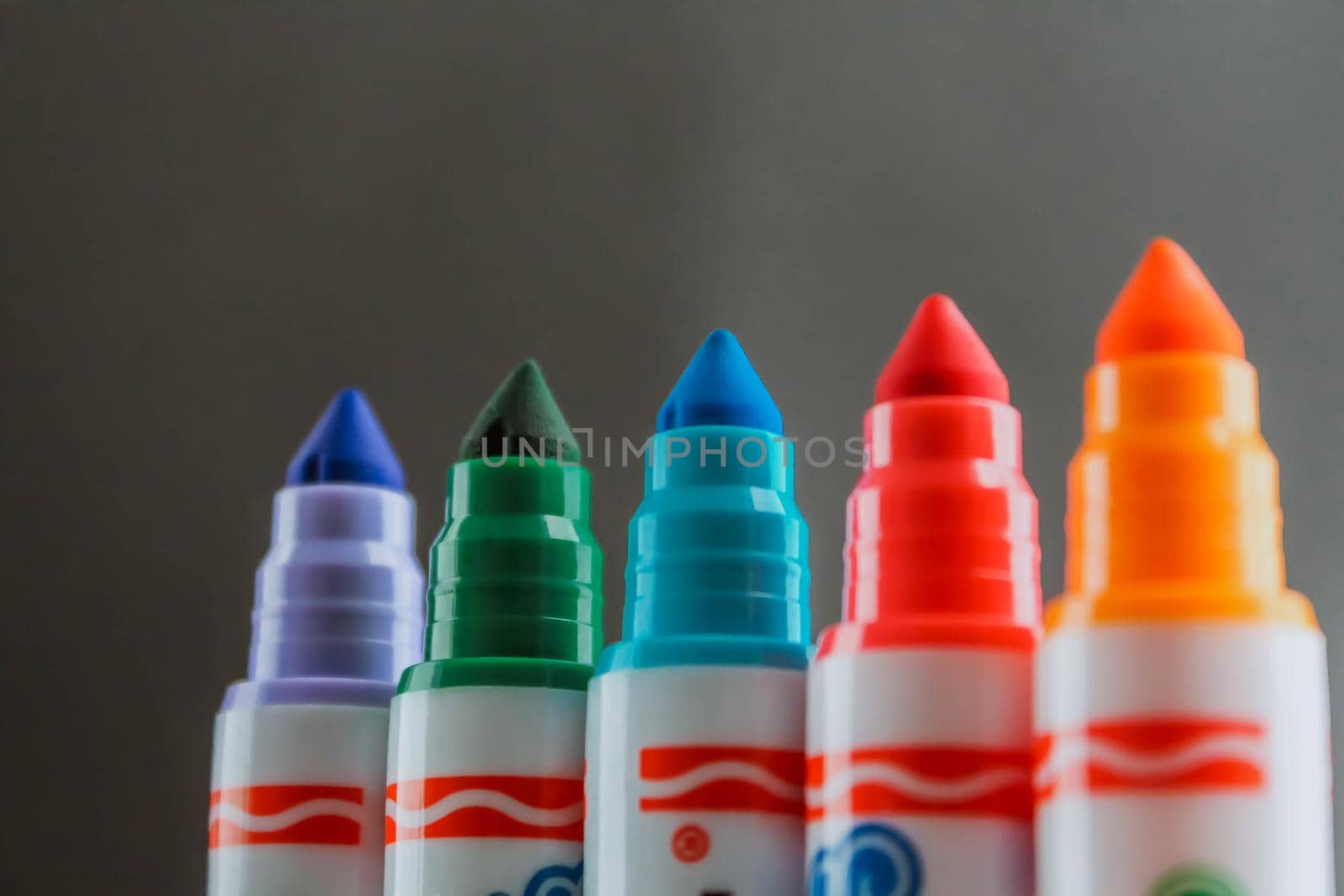 Colorful rainbow markers with blurred dark background by JuliaDorian