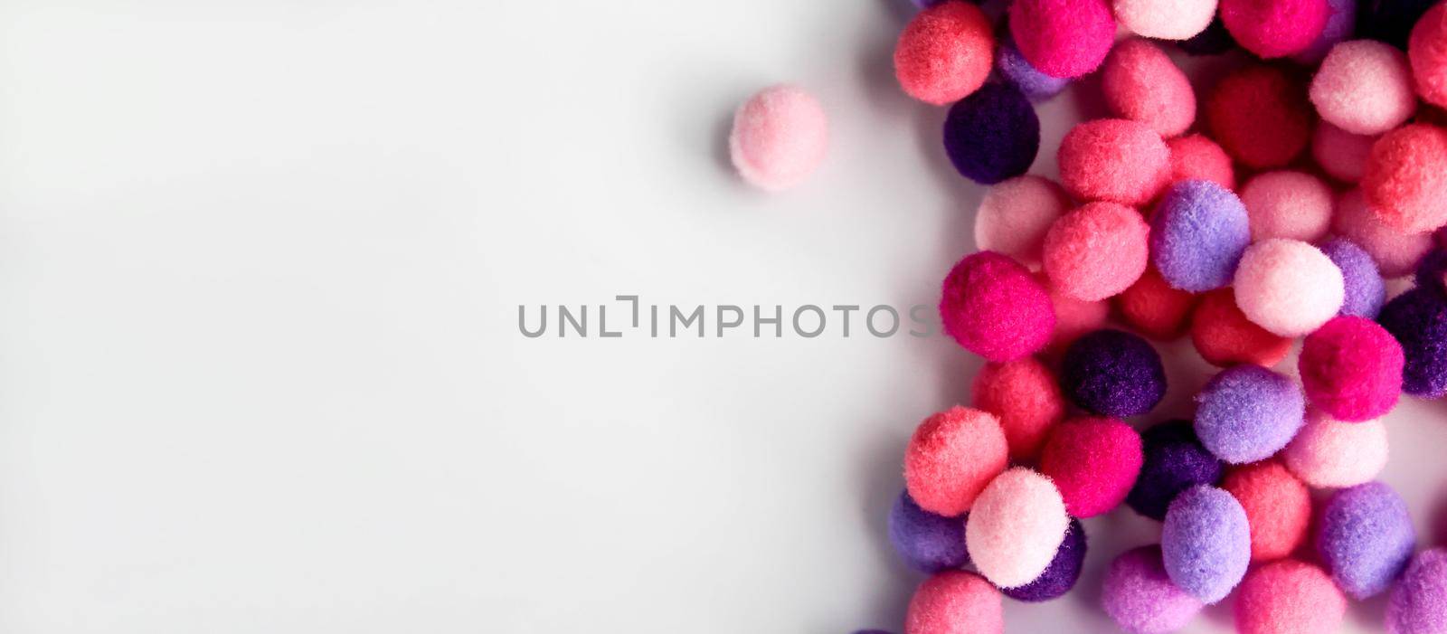 Close up colorful pom poms background, heap of small pastel color fluffy ball for crafts and fashion accessories decoration, selective focus by JuliaDorian