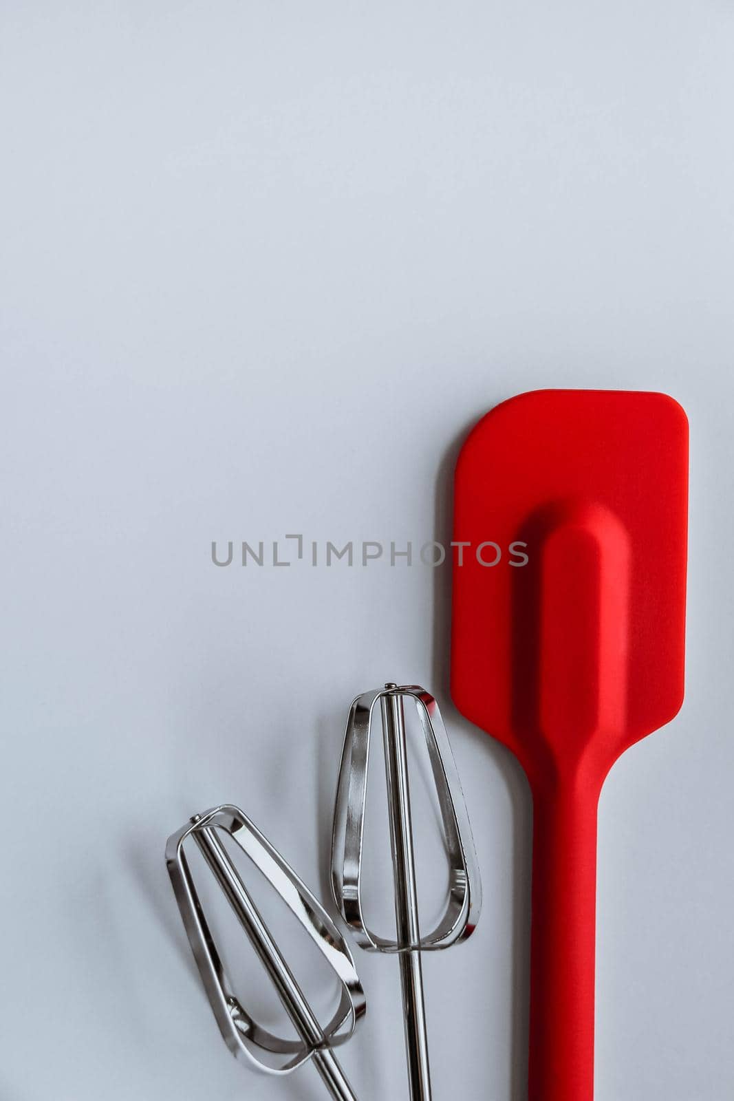 Baking supplies on white background. Spatula, mixer whisks on white background