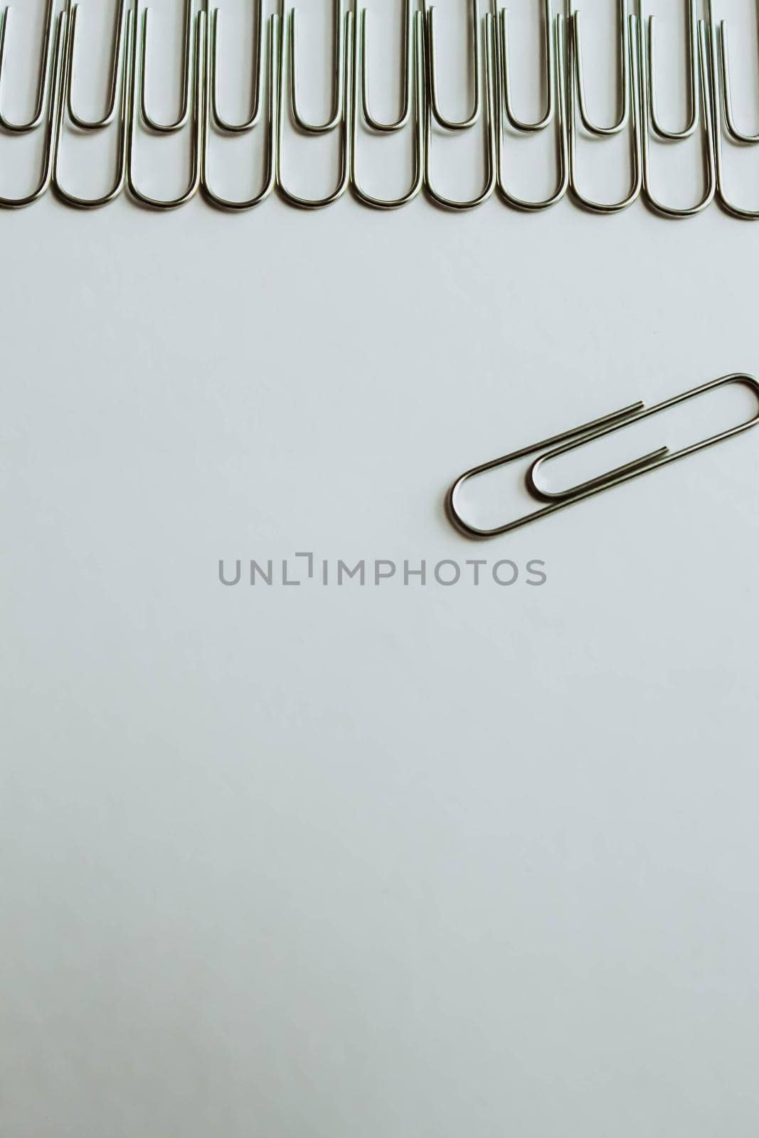 Metal paper clips on white