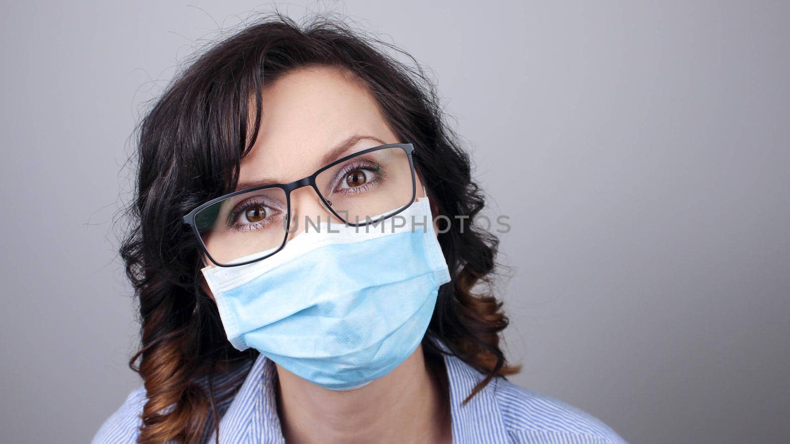 Woman wearing protection face mask against coronavirus. Woman in a mask and glasses. Medical mask, Close up shot, Select focus, Prevention from covid19