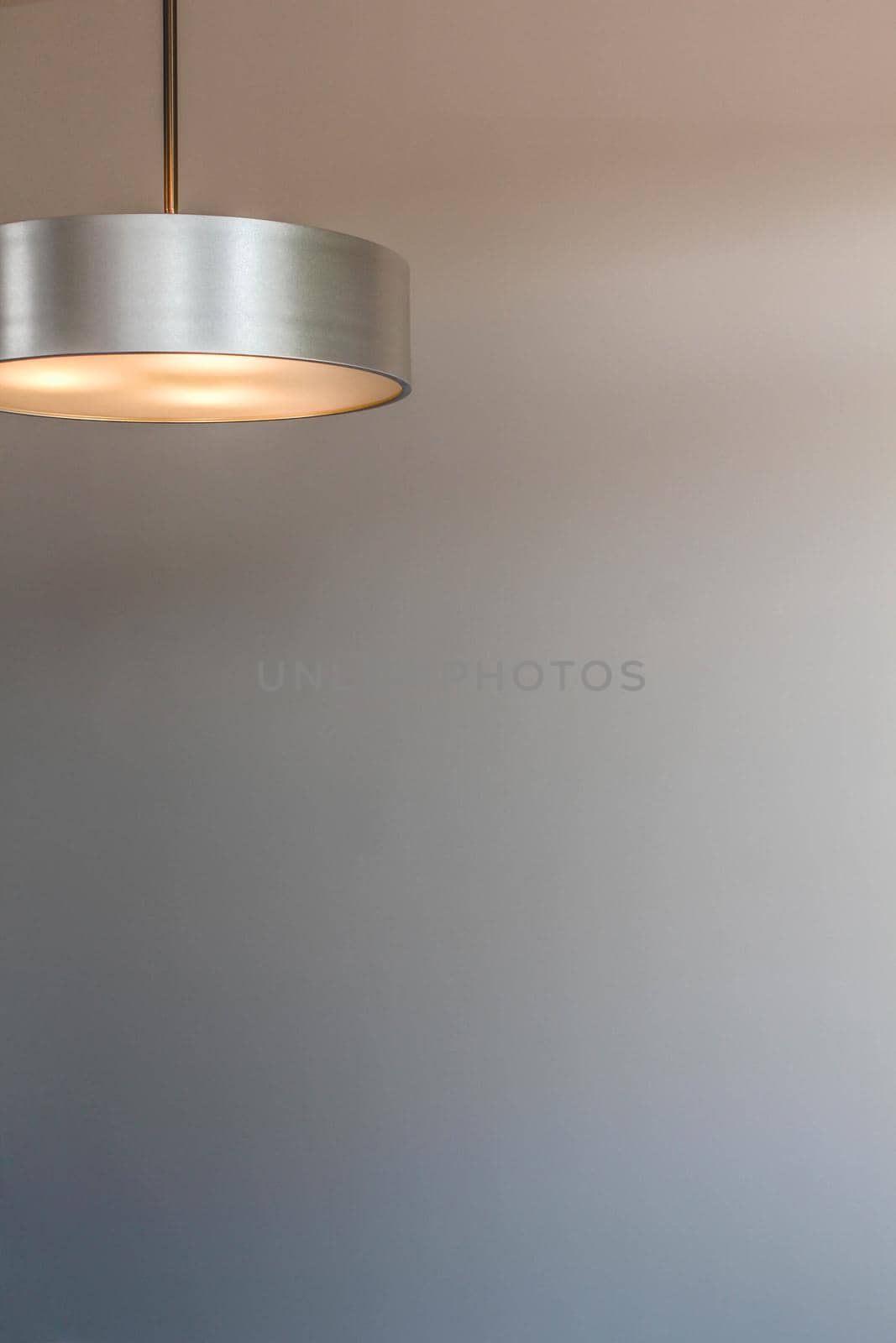 Glowing modern aluminum led lamp with white wall. Free space for text or design. by JuliaDorian