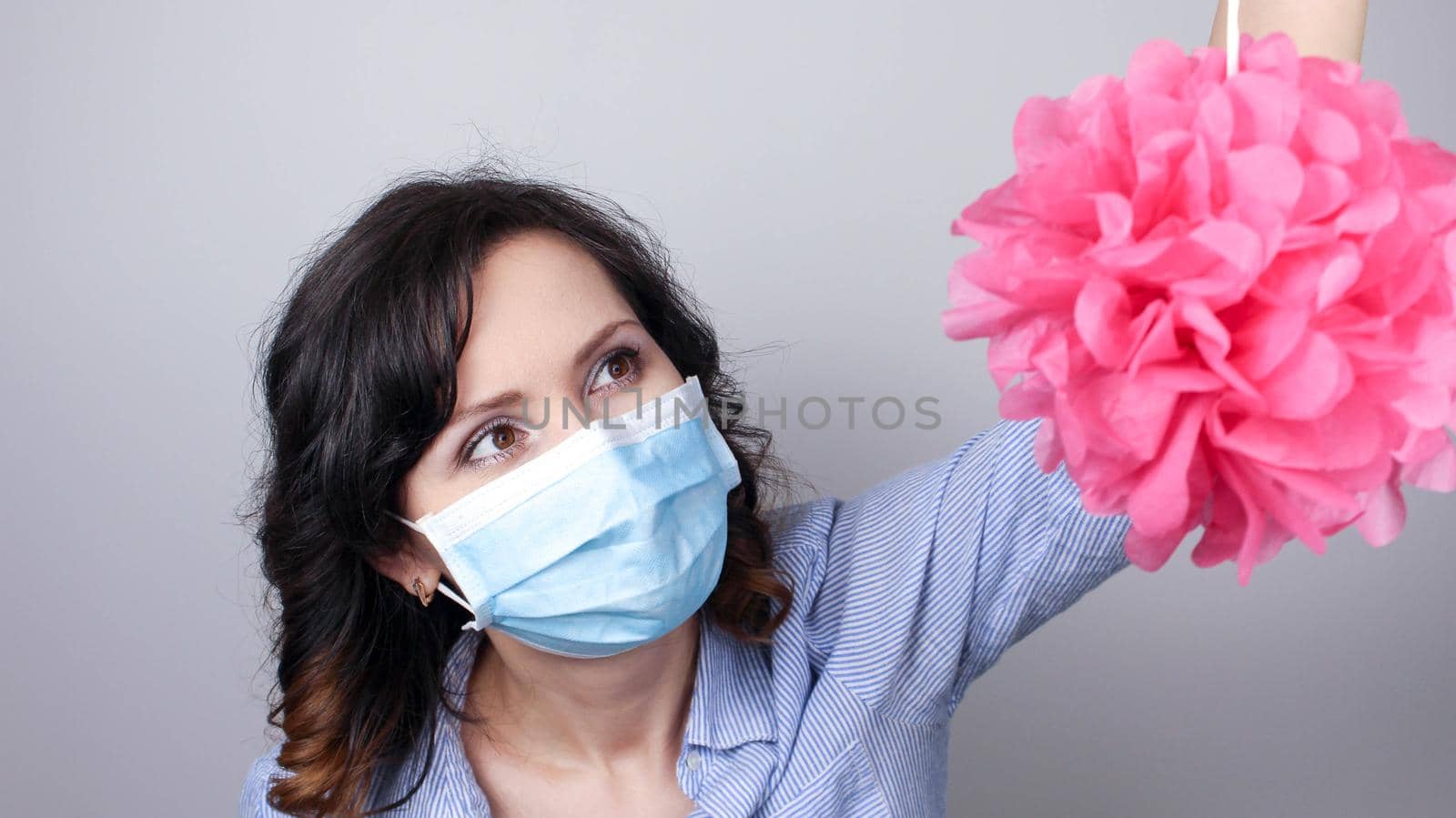 Woman wearing protection face mask against coronavirus. Woman in a mask with party supply. Birthday girl. by JuliaDorian