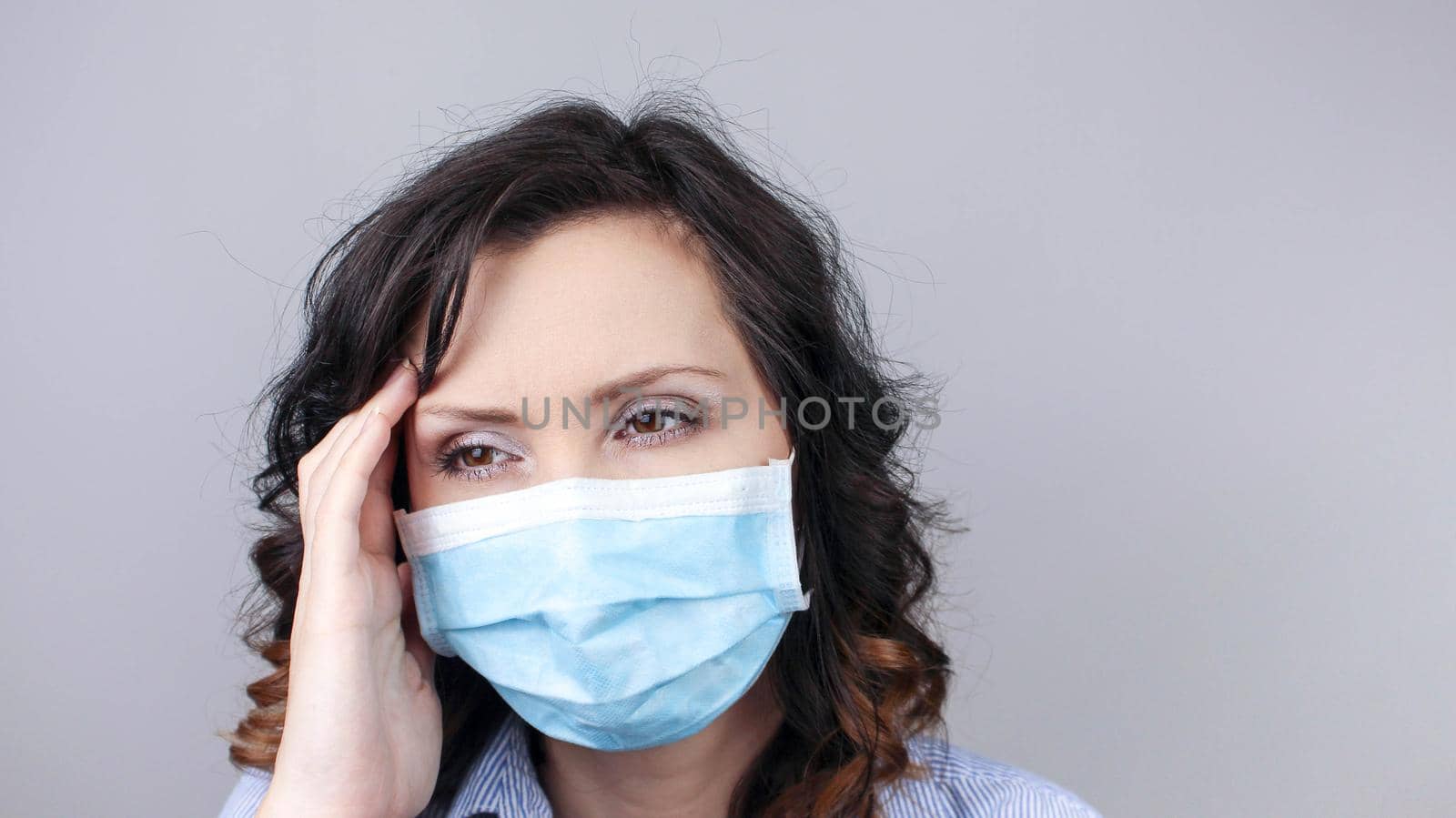 COVID-19 Pandemic Coronavirus Close up Sick Woman Headache Home Quarantine Wearing Surgical Mask. Girl with headache isolate at home with mask against Coronavirus Disease 2019. by JuliaDorian