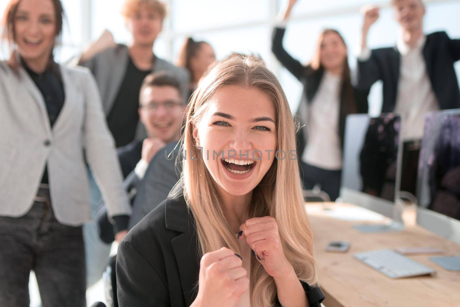 young woman on the background of a jubilant business team. success concept