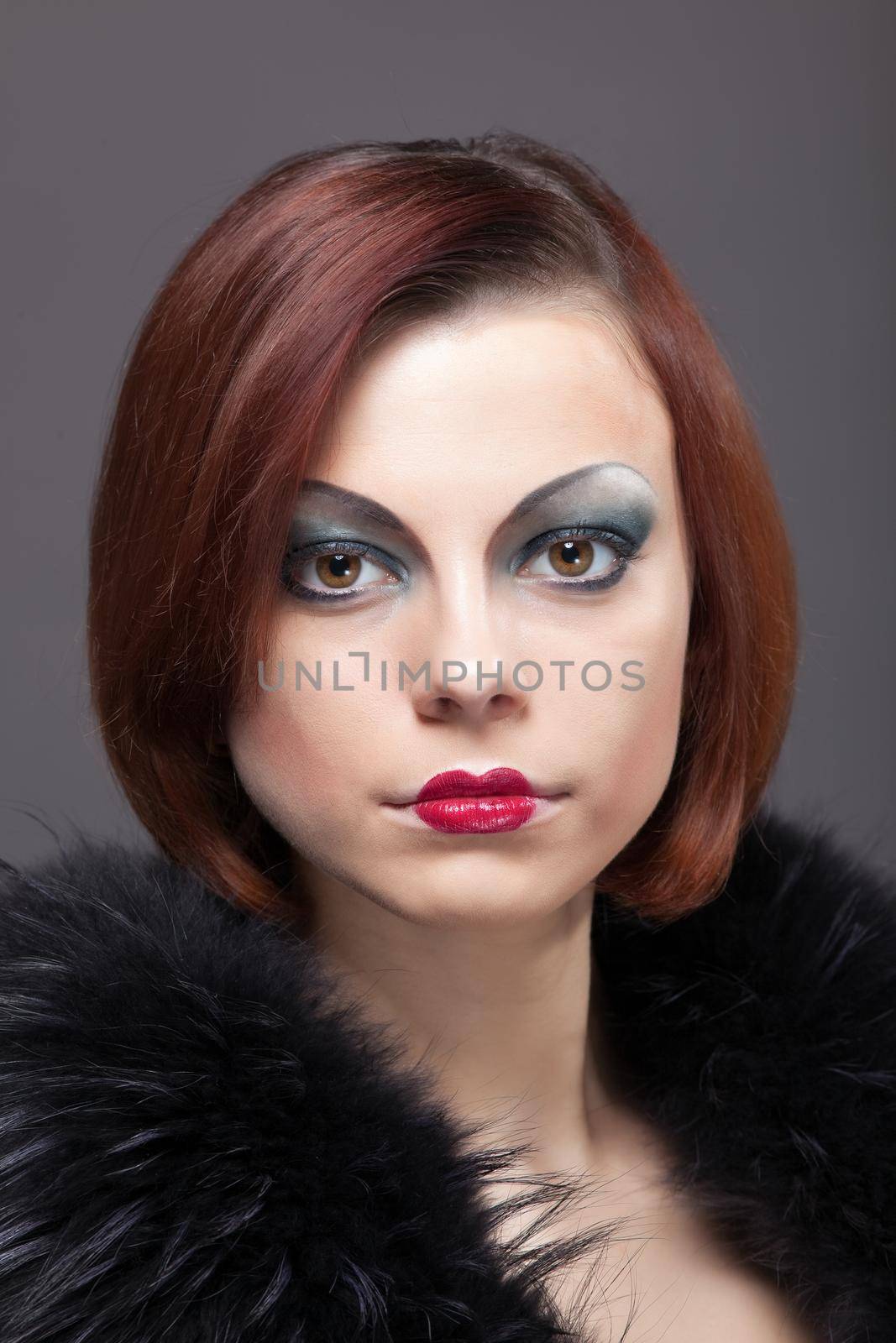 Woman portrait with fur boa in retro style make-up