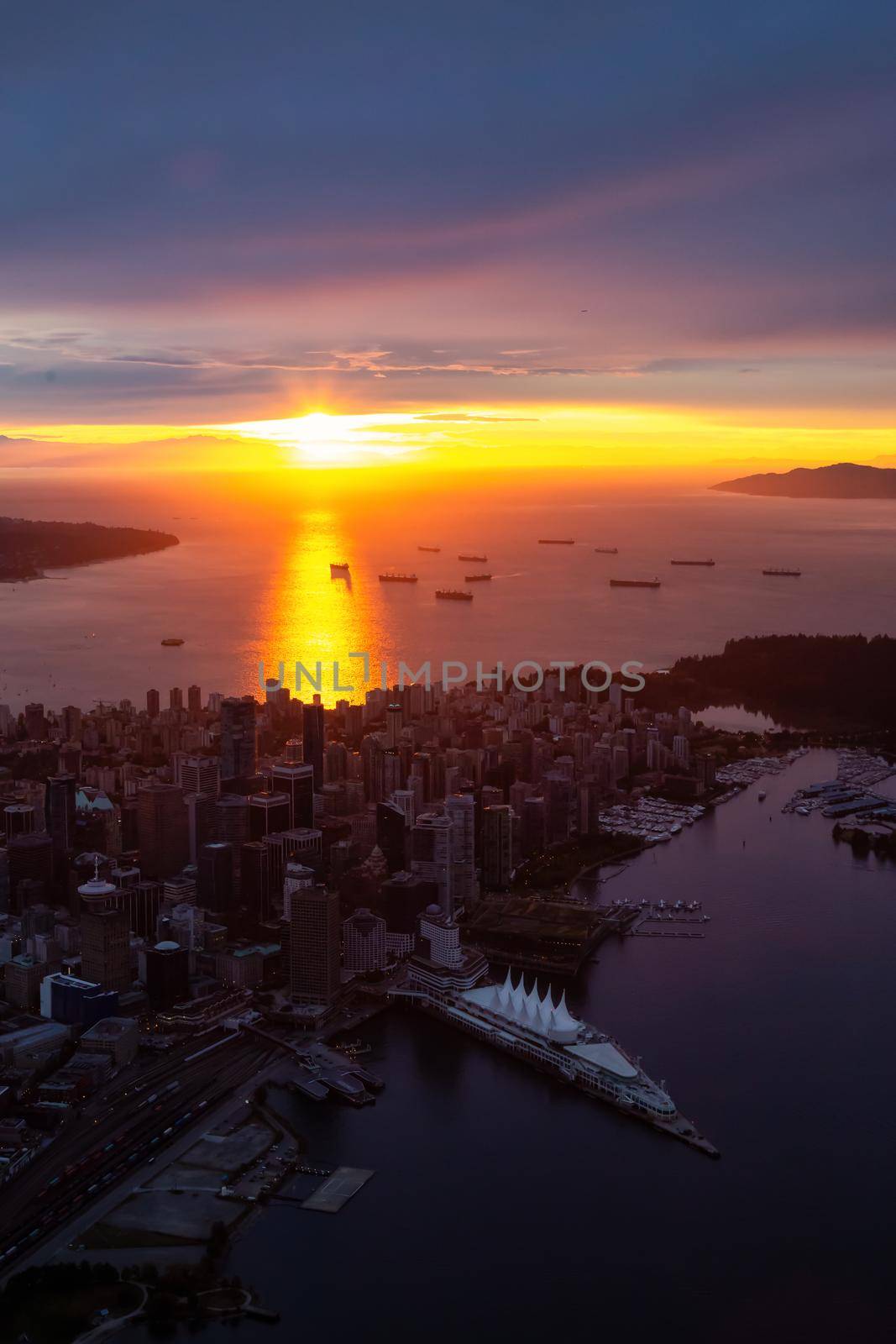 Aerial view of Downtown City during a striking and dramatic sunset. Taken in Vancouver, British Columbia, Canada.