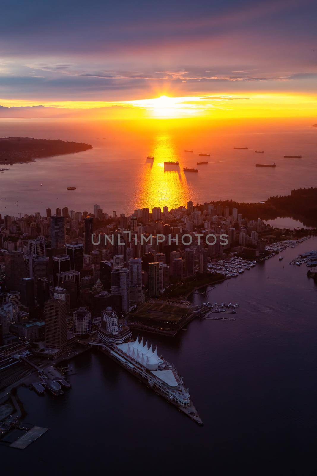 Aerial view of Downtown City during a striking and dramatic sunset. Taken in Vancouver, British Columbia, Canada.