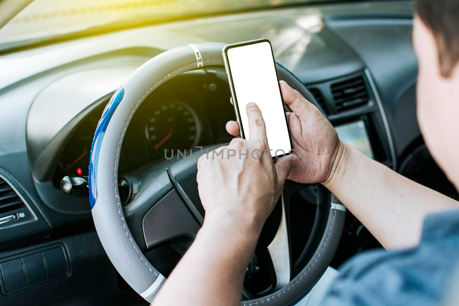 Close up of driver hands using his phone, Person in his car using cell phone, Concept driver hands touching cell phone screen by isaiphoto