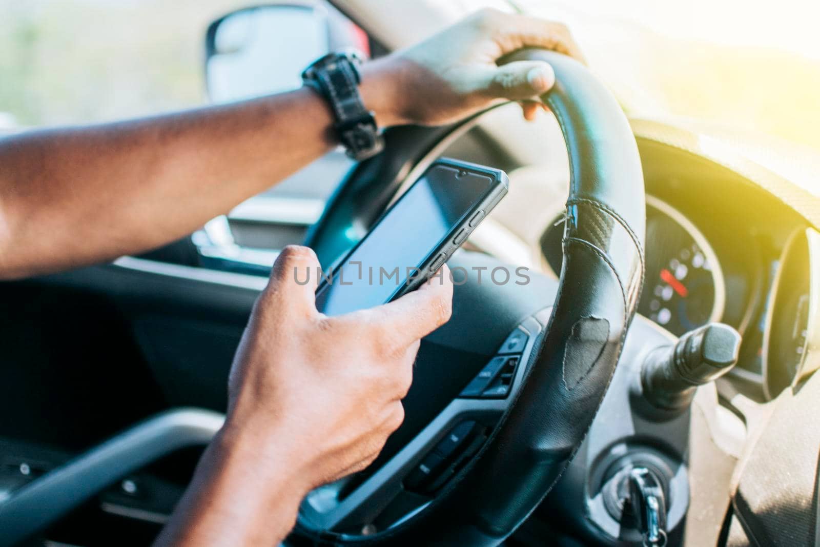 Person in his car using cell phone, Close up of driver hands using his phone, Concept driver hands touching cell phone screen