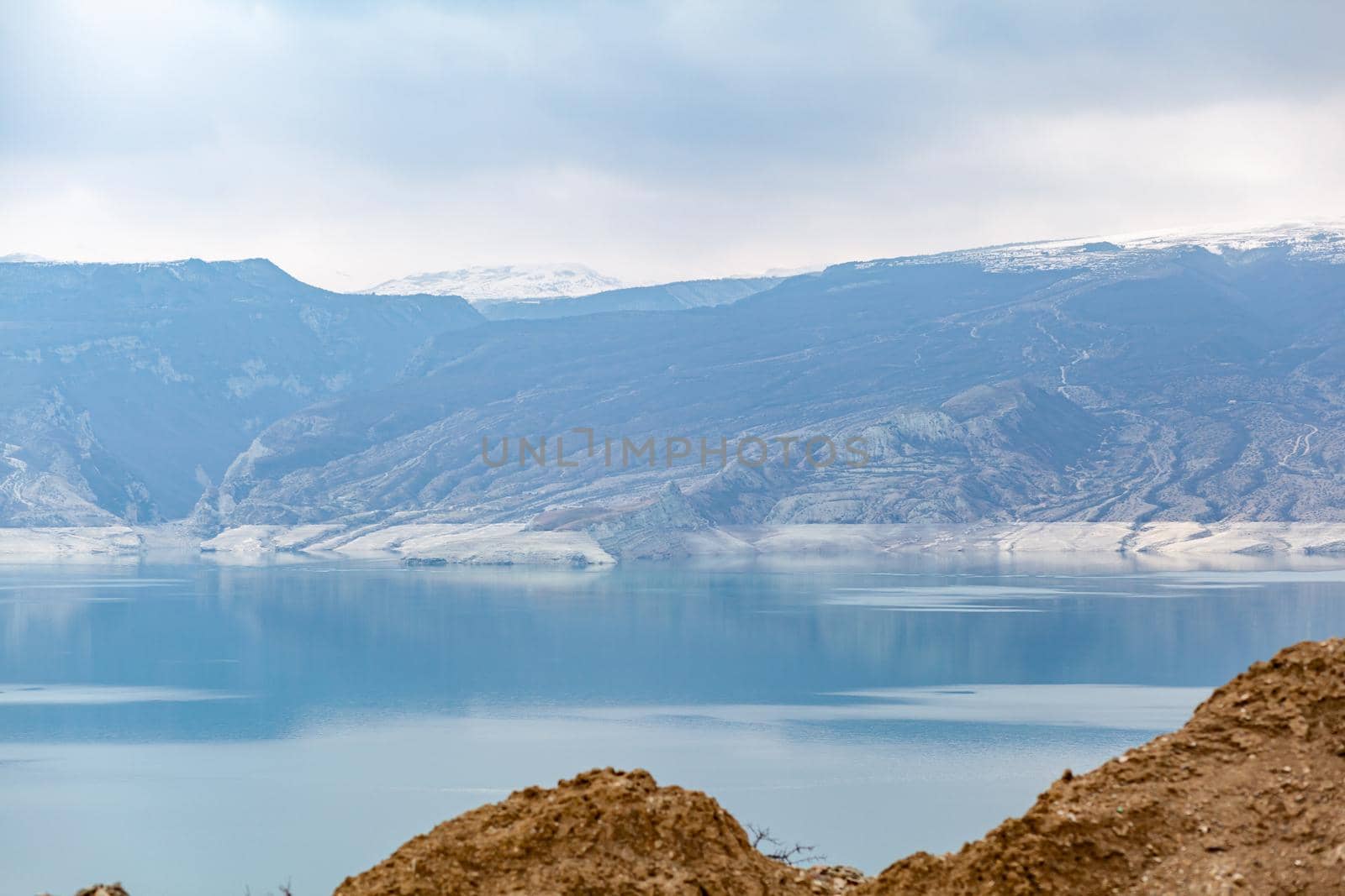 A beautiful reservoir in the mountains. Low water level, drought by AnatoliiFoto
