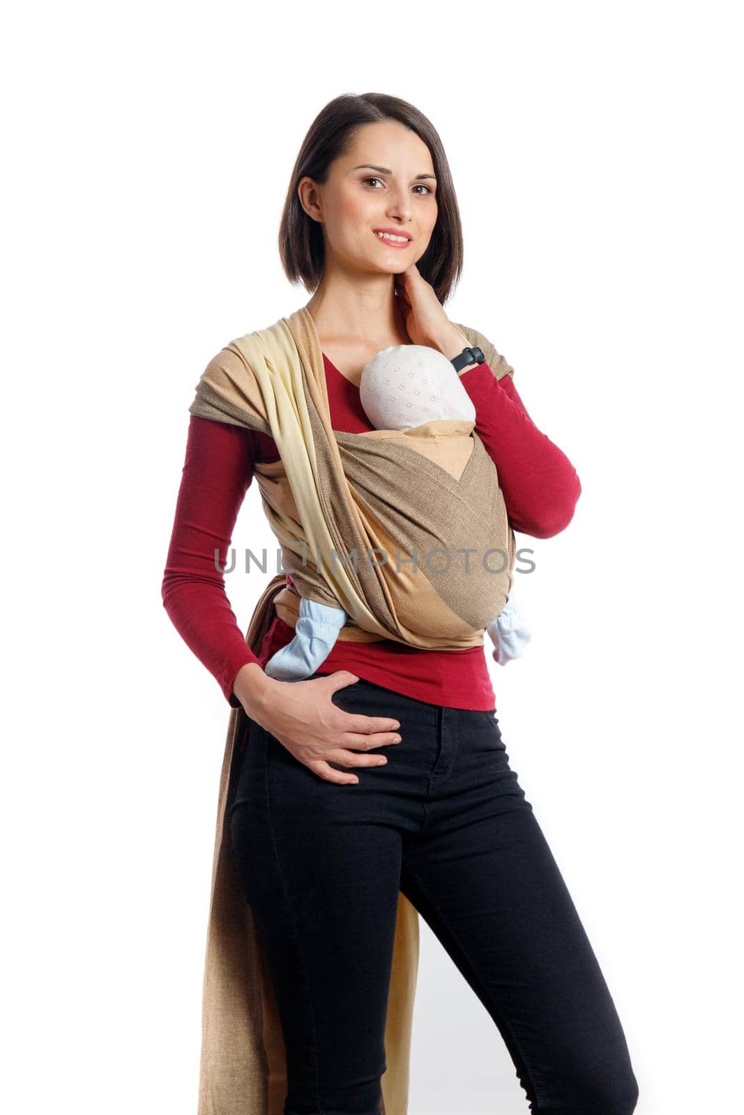 Babywearing attractive young mother with baby in woven wrap carrier. Free hands and active motherhood concept idea. Isolated on white background