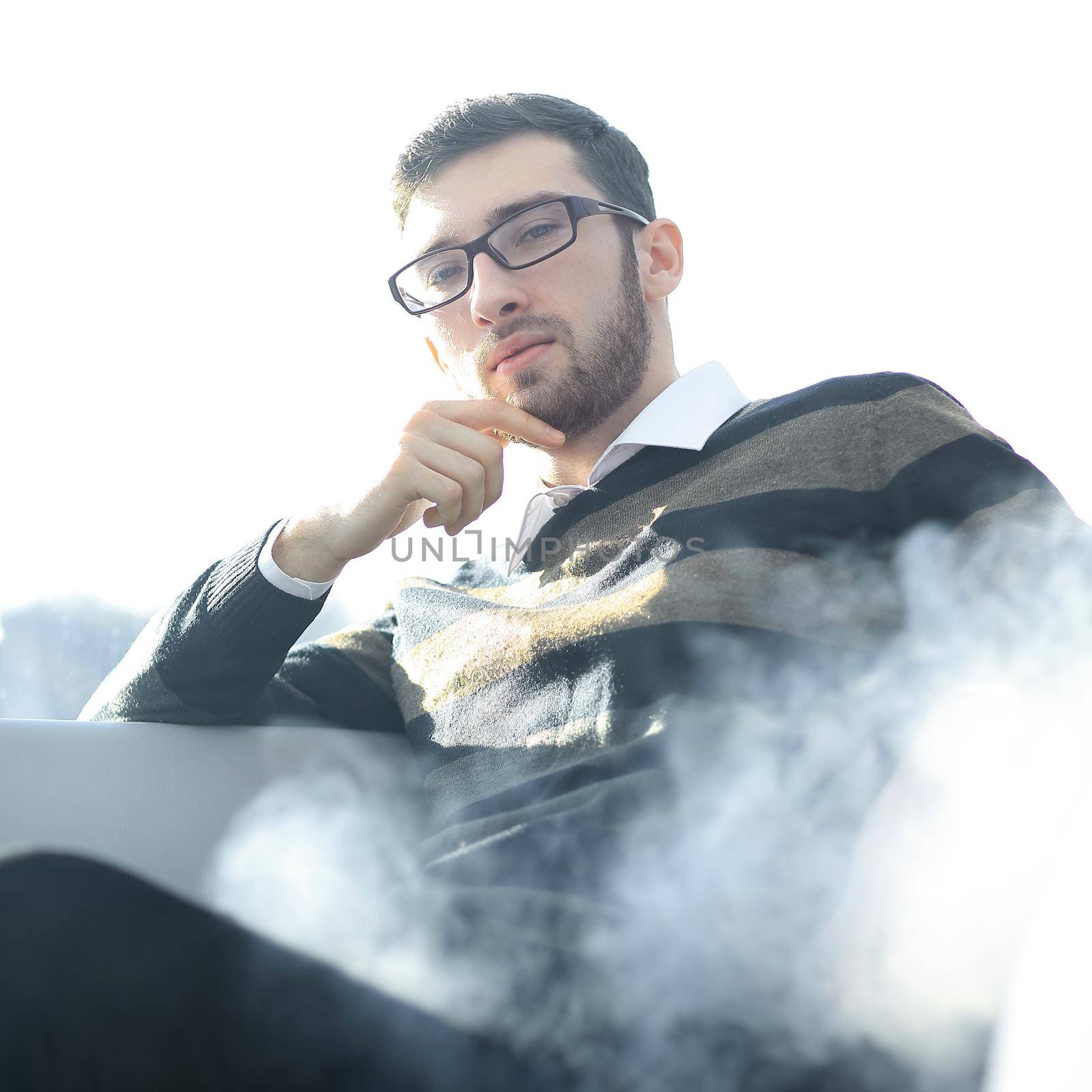 close up. businessman with a cigarette during a coffee break.