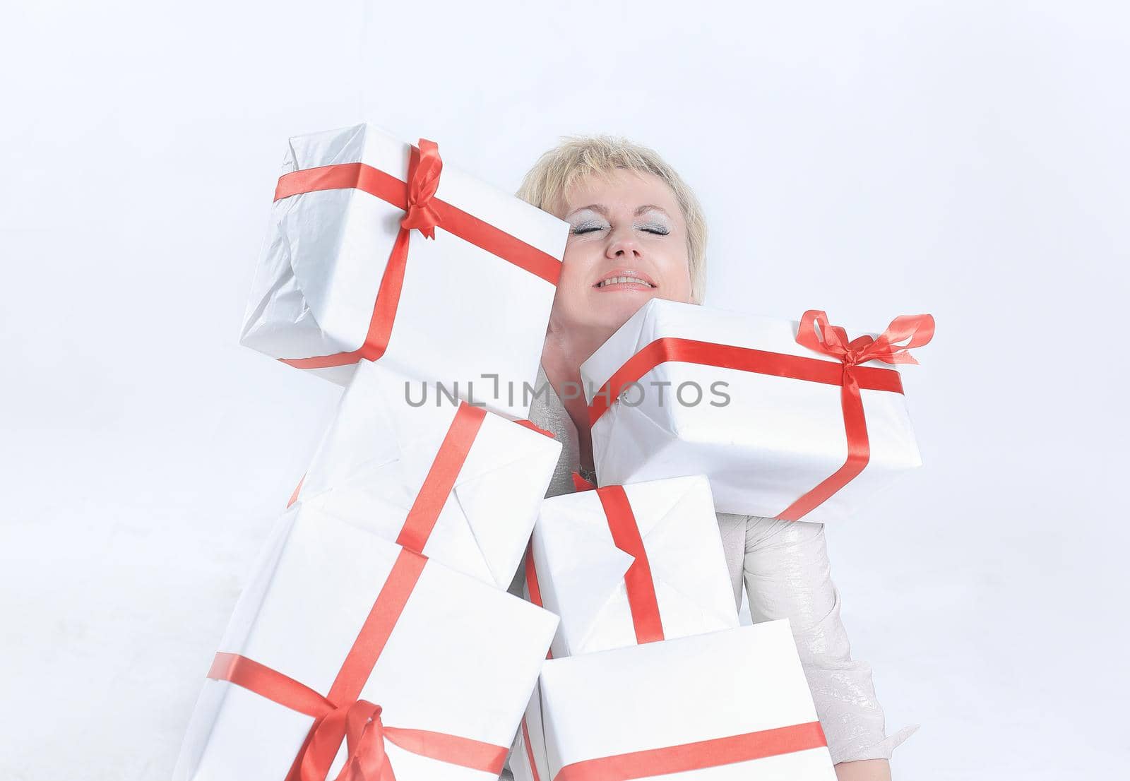 closeup of woman with lots of gift boxes.isolated on a white background.