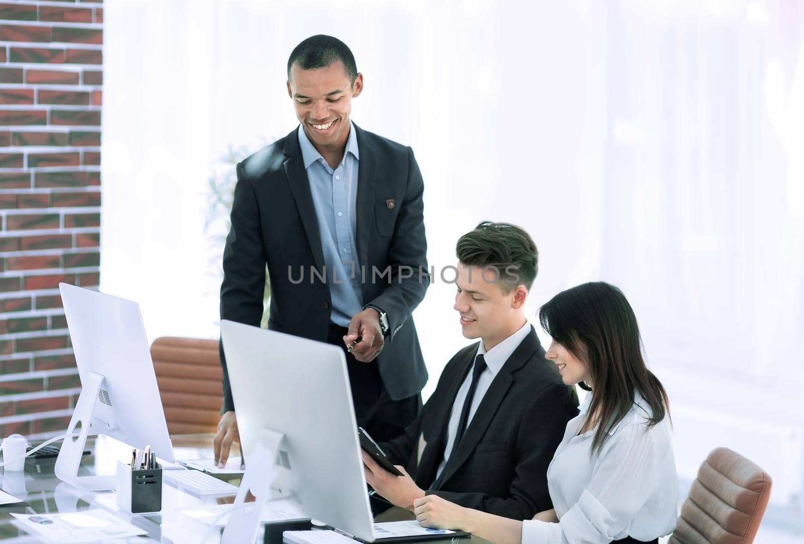 business team working with documents in a modern office. by SmartPhotoLab