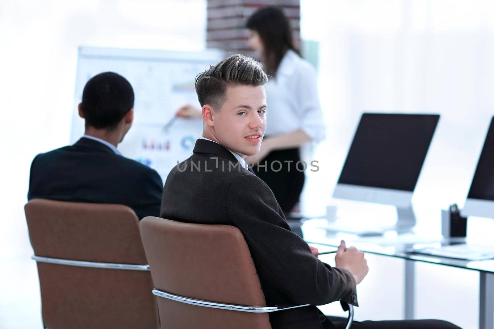 employee of the company on the background of business team in a modern office