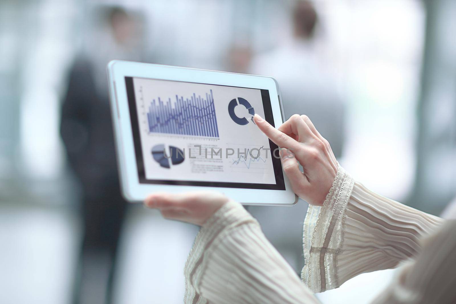 close up.a business woman points her finger at the financial chart.