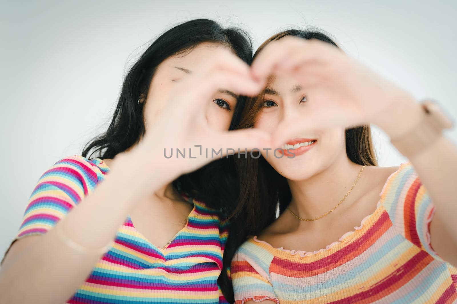 lgbtq, lgbt concept, homosexuality, portrait of two Asian women posing happy together and showing love for each other while being together.