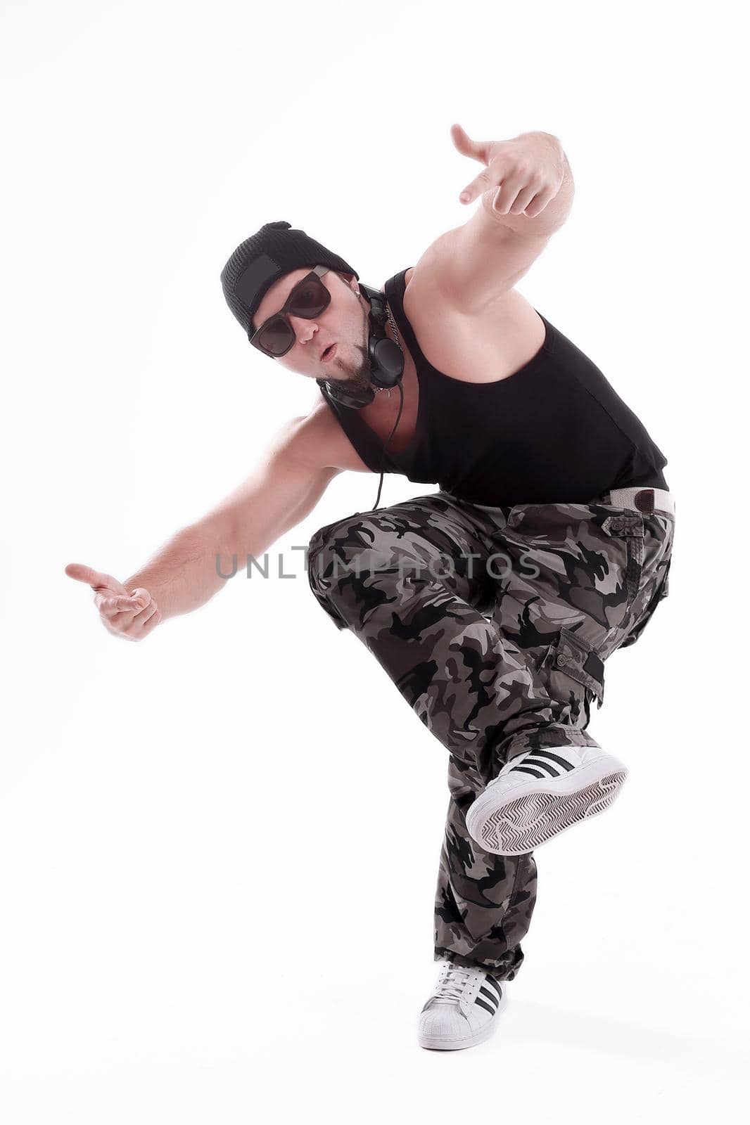 in full growth.Studio portrait of a tough rapper in sunglasses .isolated on white background.