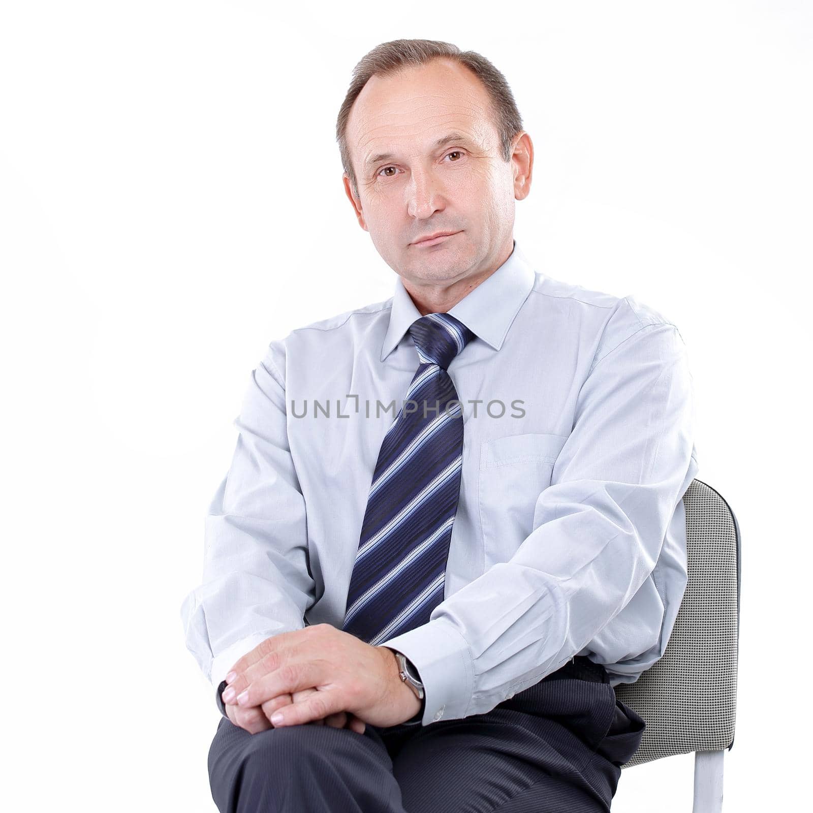 serious businessman sitting in an office chair