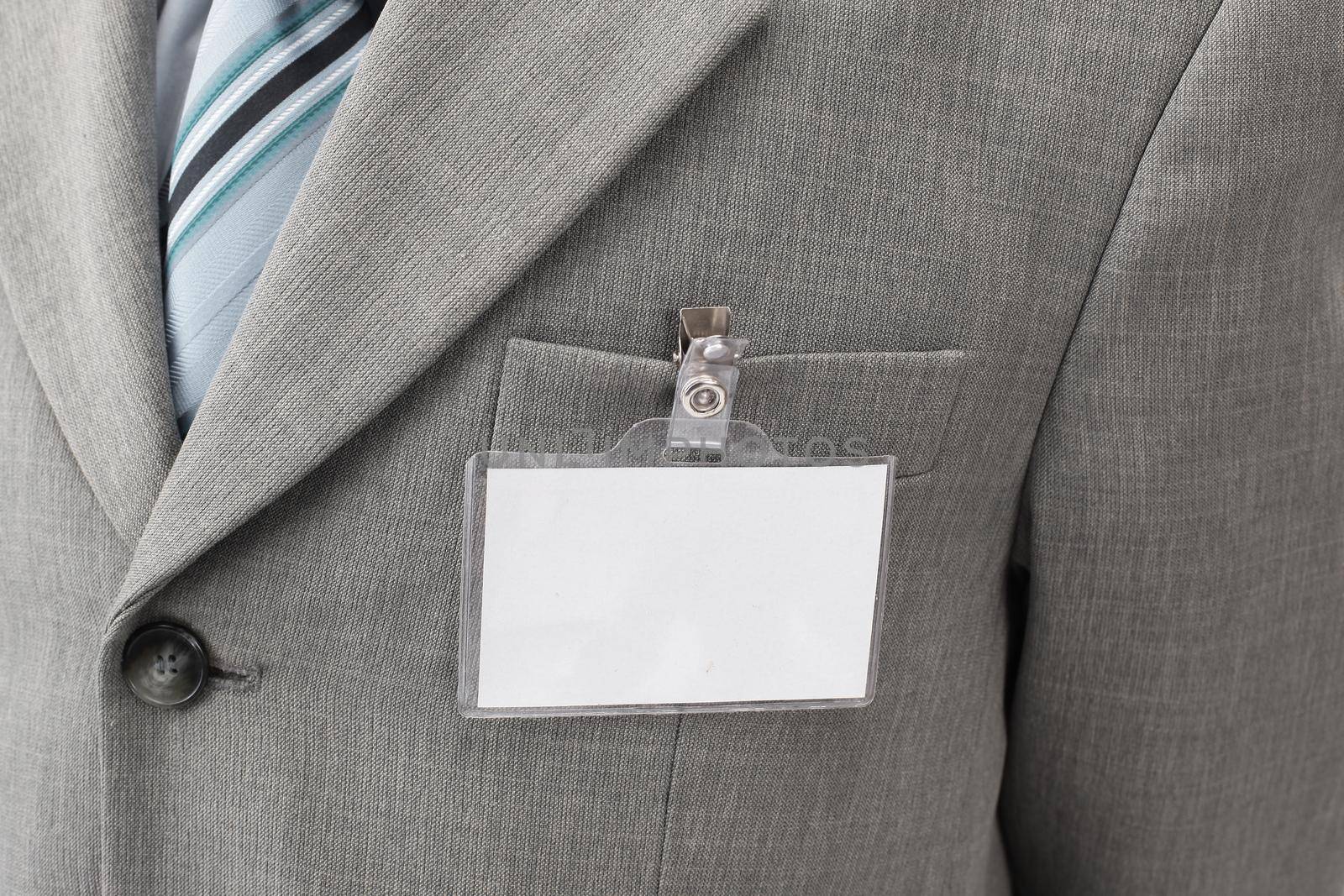 White blank name tag is attached to chest in the businessman .