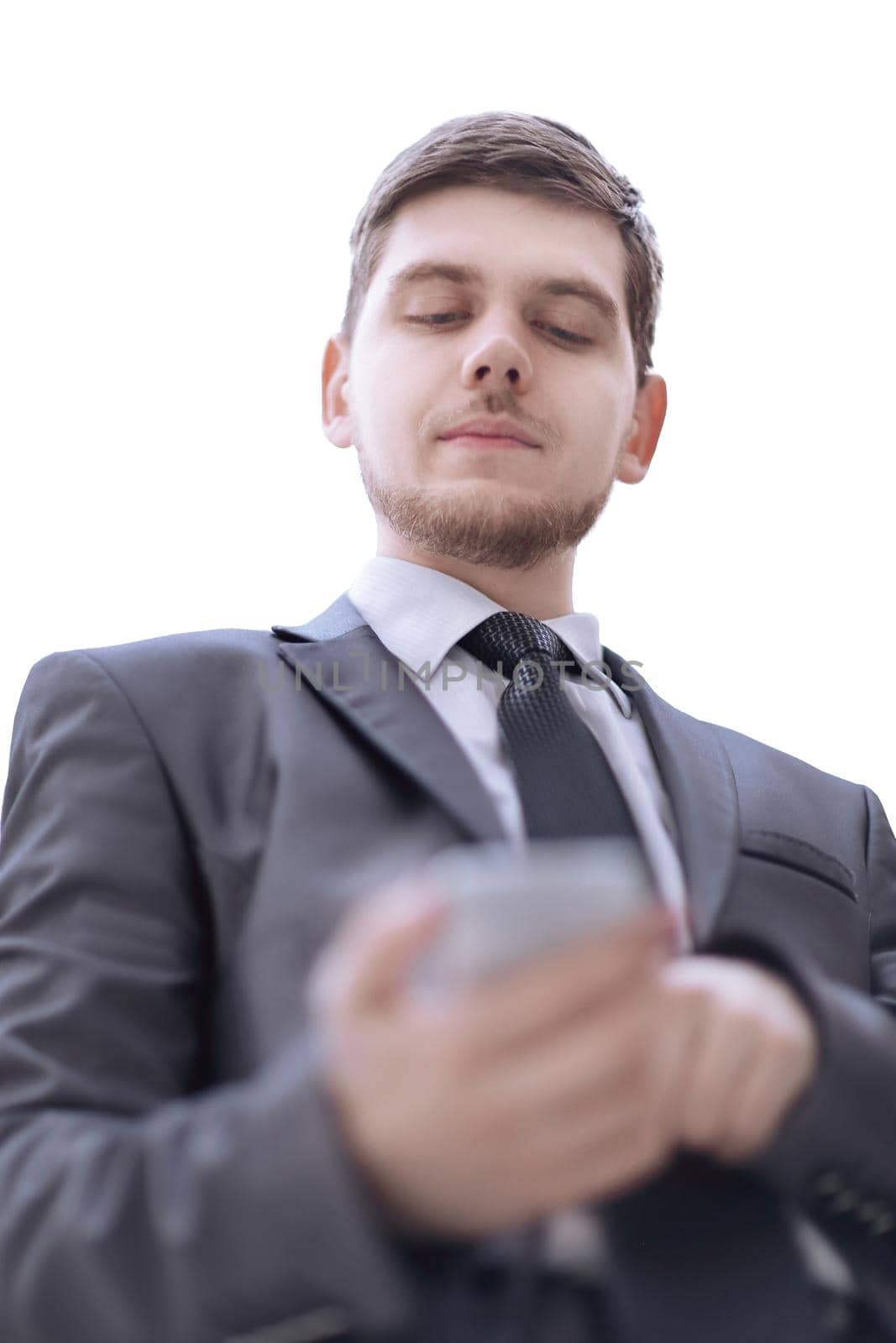 close up.serious businessman reading text message on smartphone.