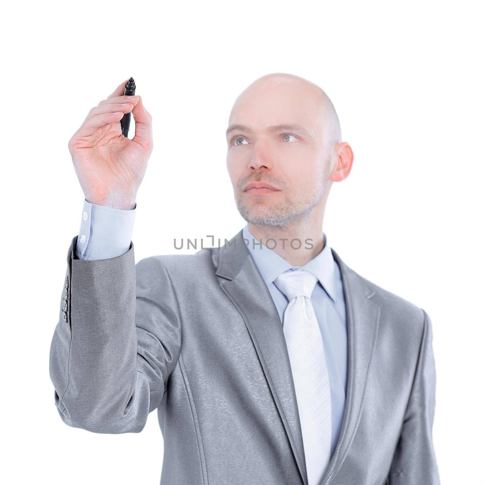 serious businessman pointing a marker at the virtual point.isolated on white