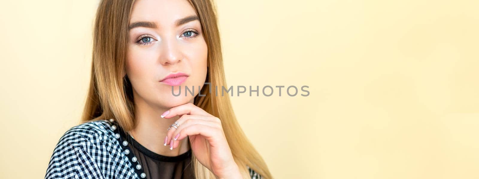 Portrait of a casual business woman sitting at her workplace in home office.