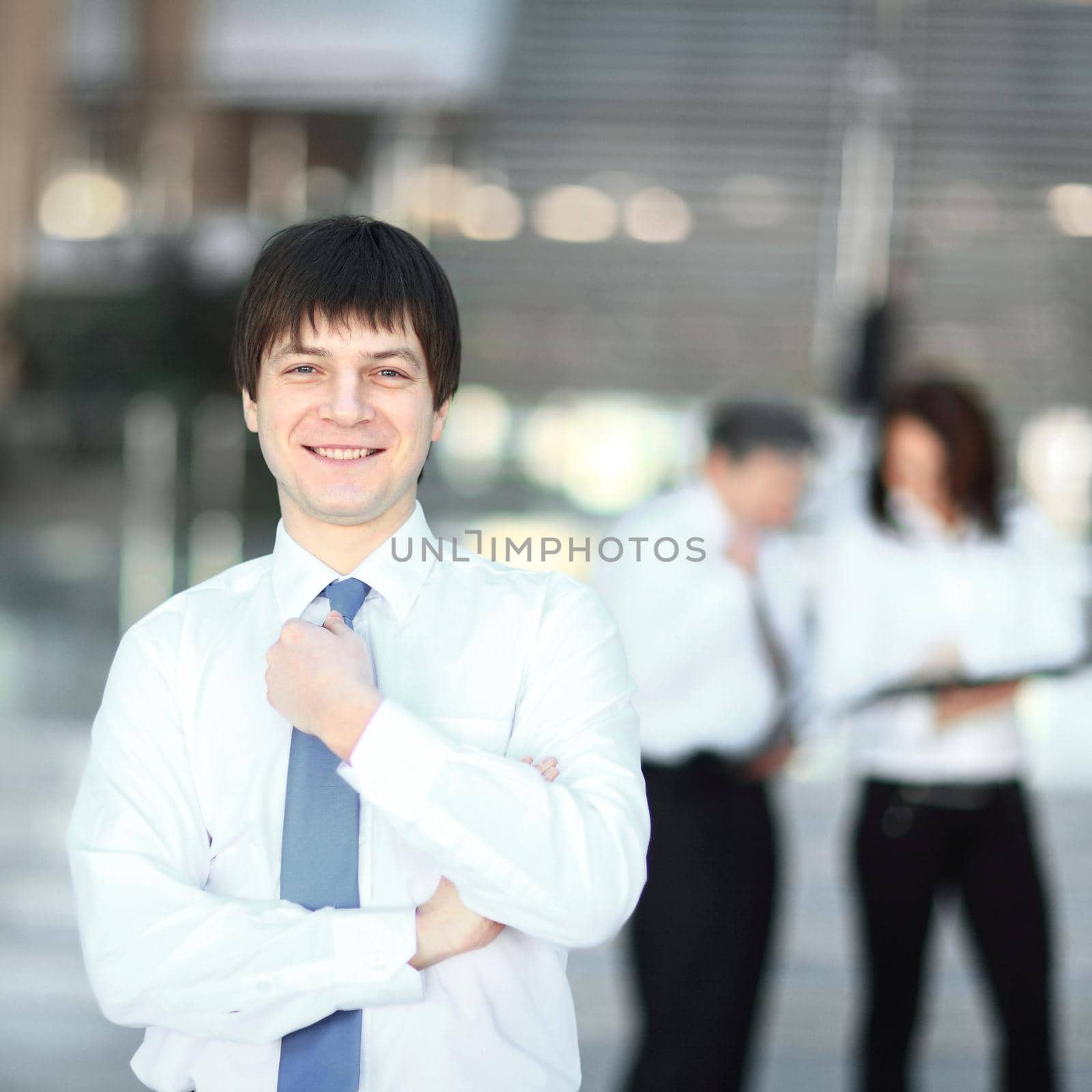 successful young employee on blurred background office.photo with copy space