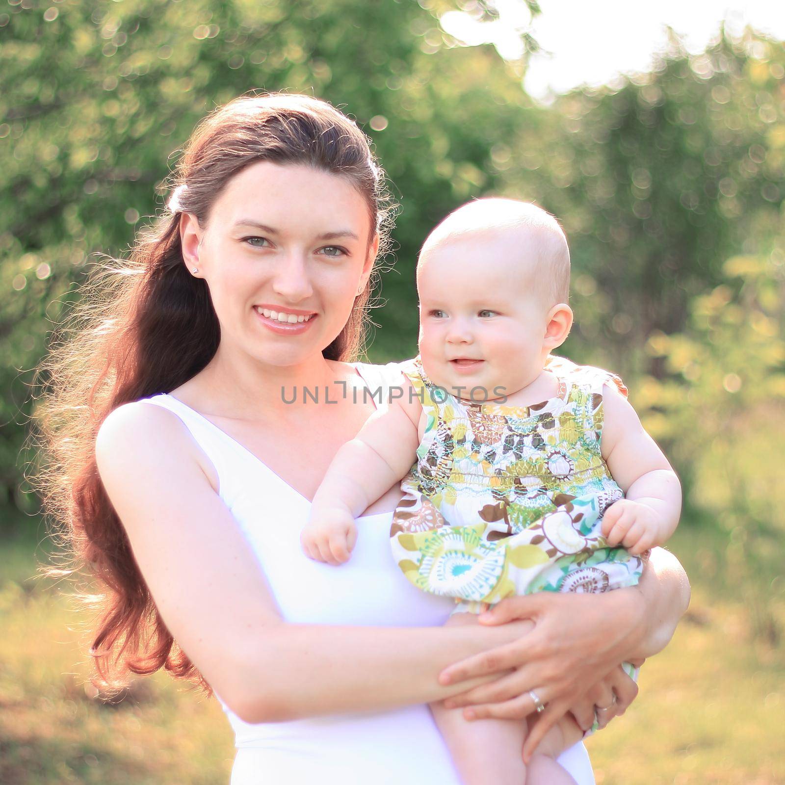 smiling mother and happy daughter on a walk in the Park by SmartPhotoLab