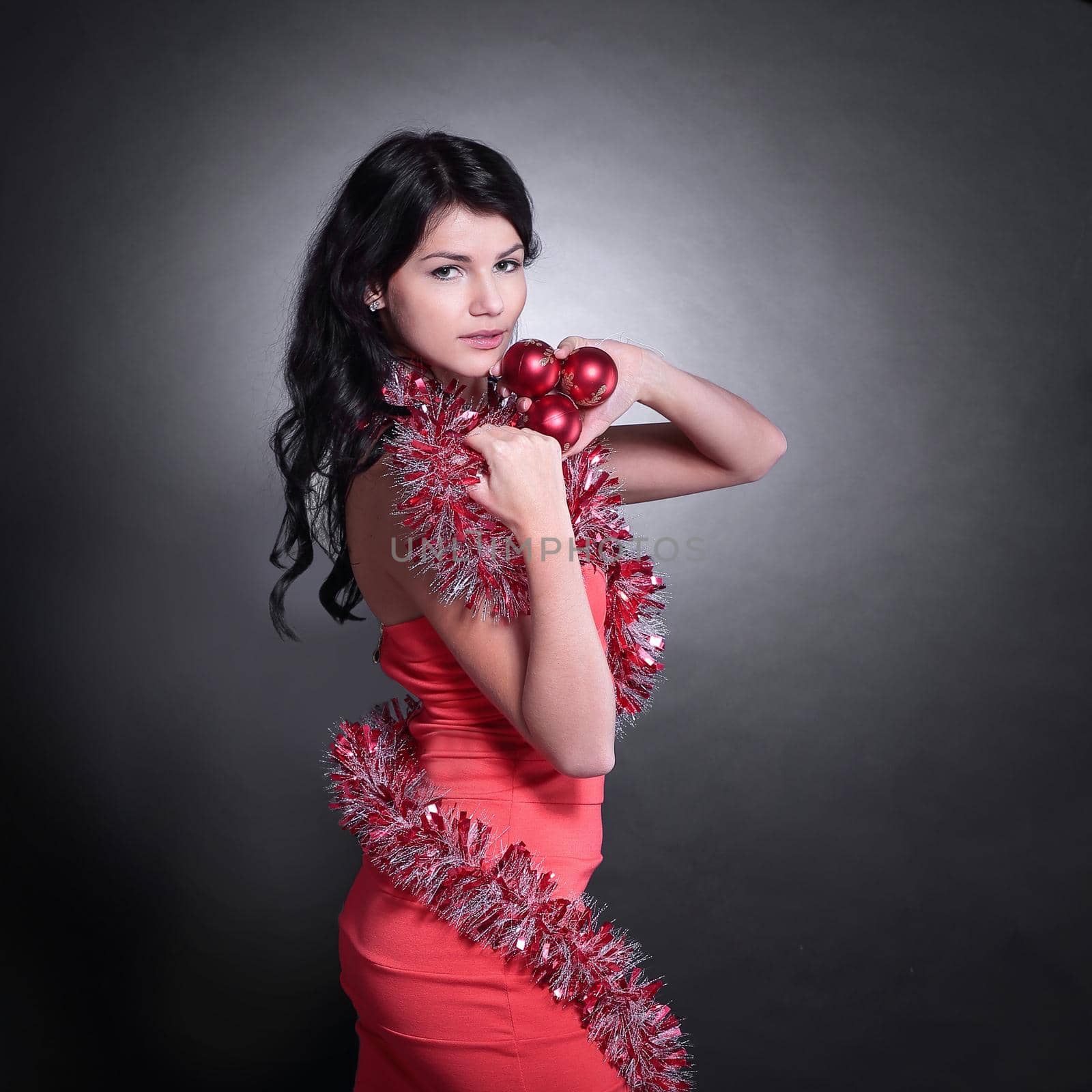 side view.beautiful young woman in a red dress. isolated on blac by SmartPhotoLab