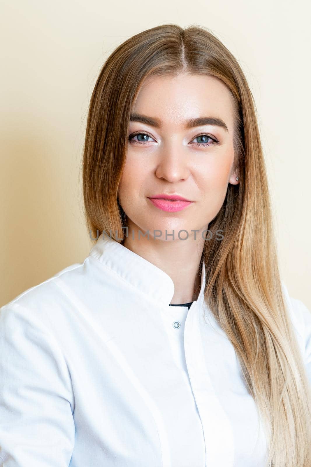 Vertical portrait of beautiful young woman wearing white shirt on yellow background.