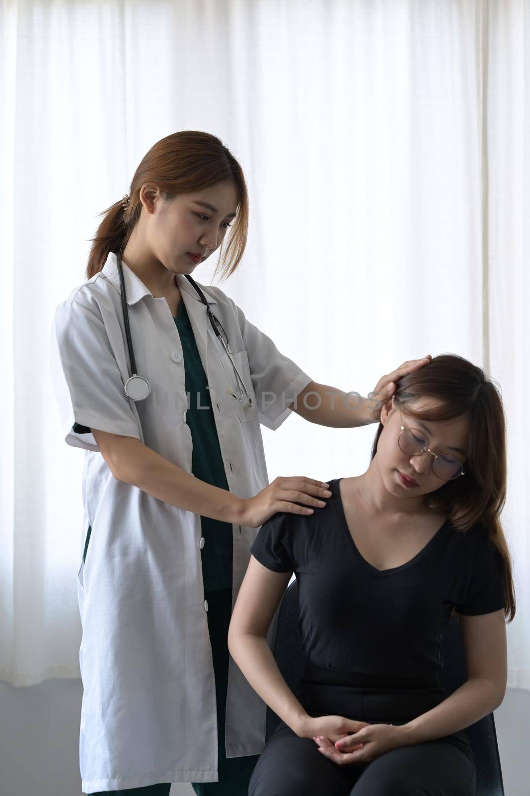 A physiotherapist making neck massage to female patient. Physical therapy concept.