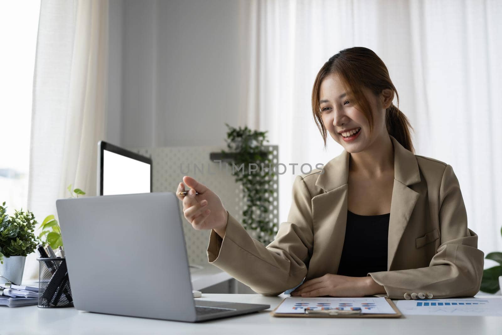Smiling female employee working in modern office.