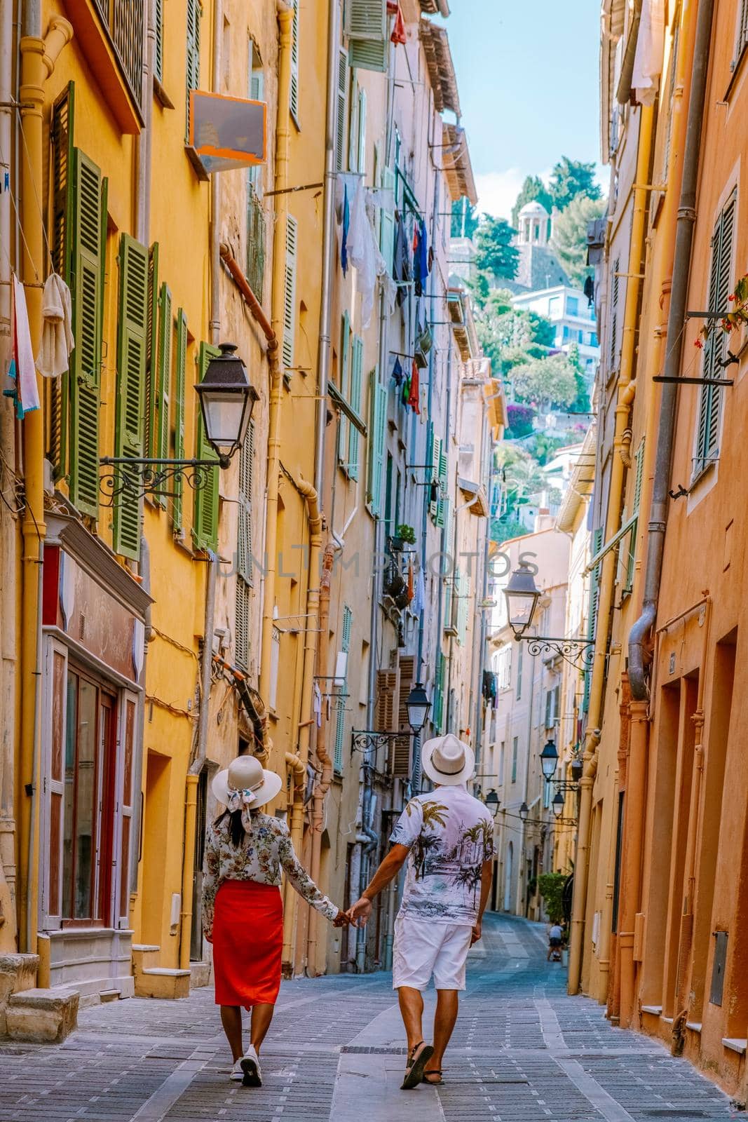 Menton France,couple men and woman on vacation at the Cote d Azur France, View on old part of Menton, Provence-Alpes-Cote d'Azur, France Europe