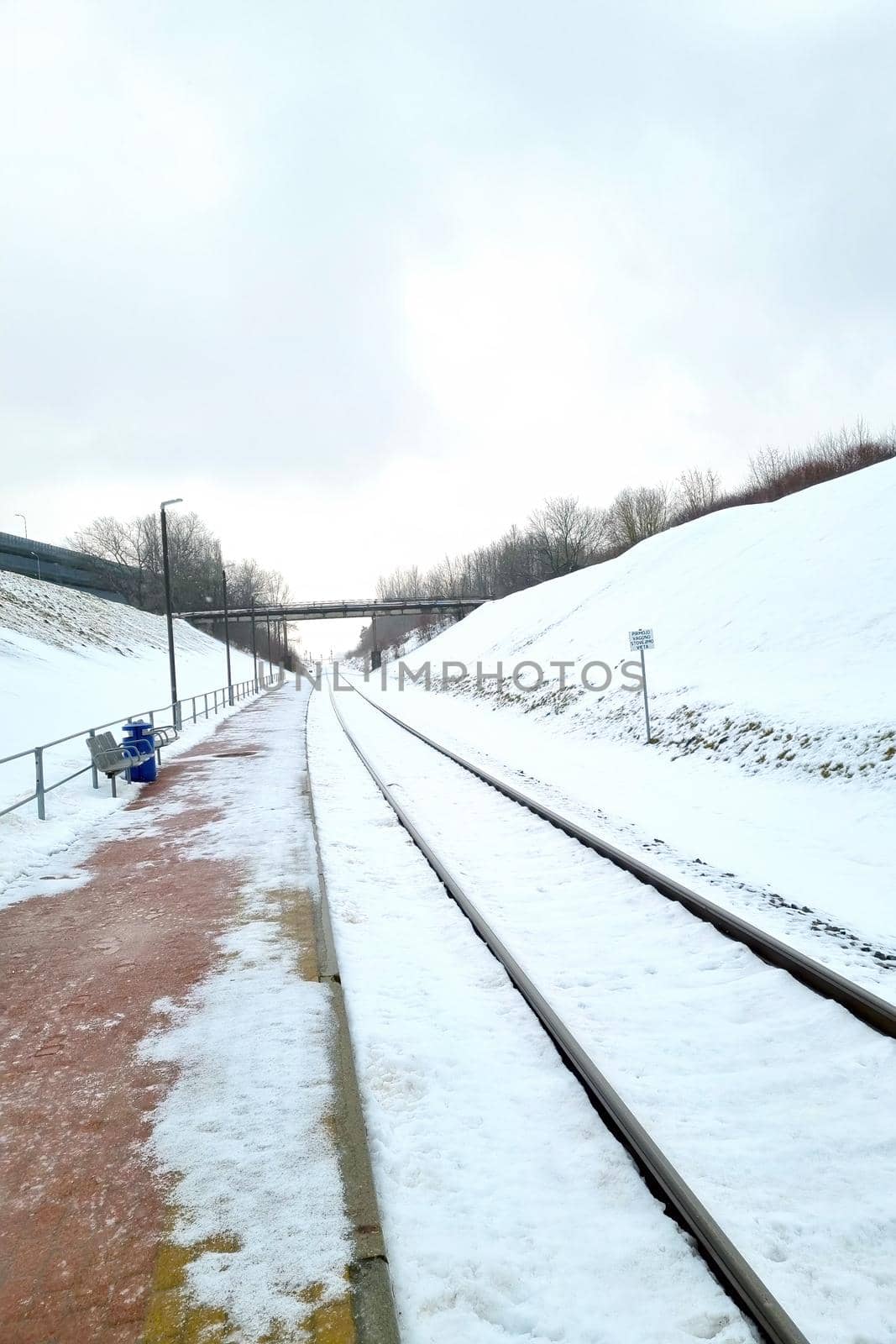 View of the empty platform of the railway station on a winter day