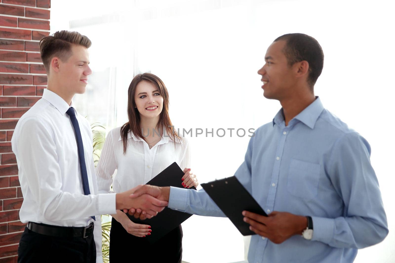 handshake of young business partners in the office.the business concept .photo with copy space