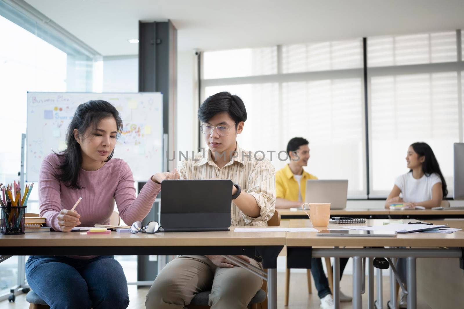 Group of business people brainstorming and discussing ideas of the new startup project together at modern office. by prathanchorruangsak