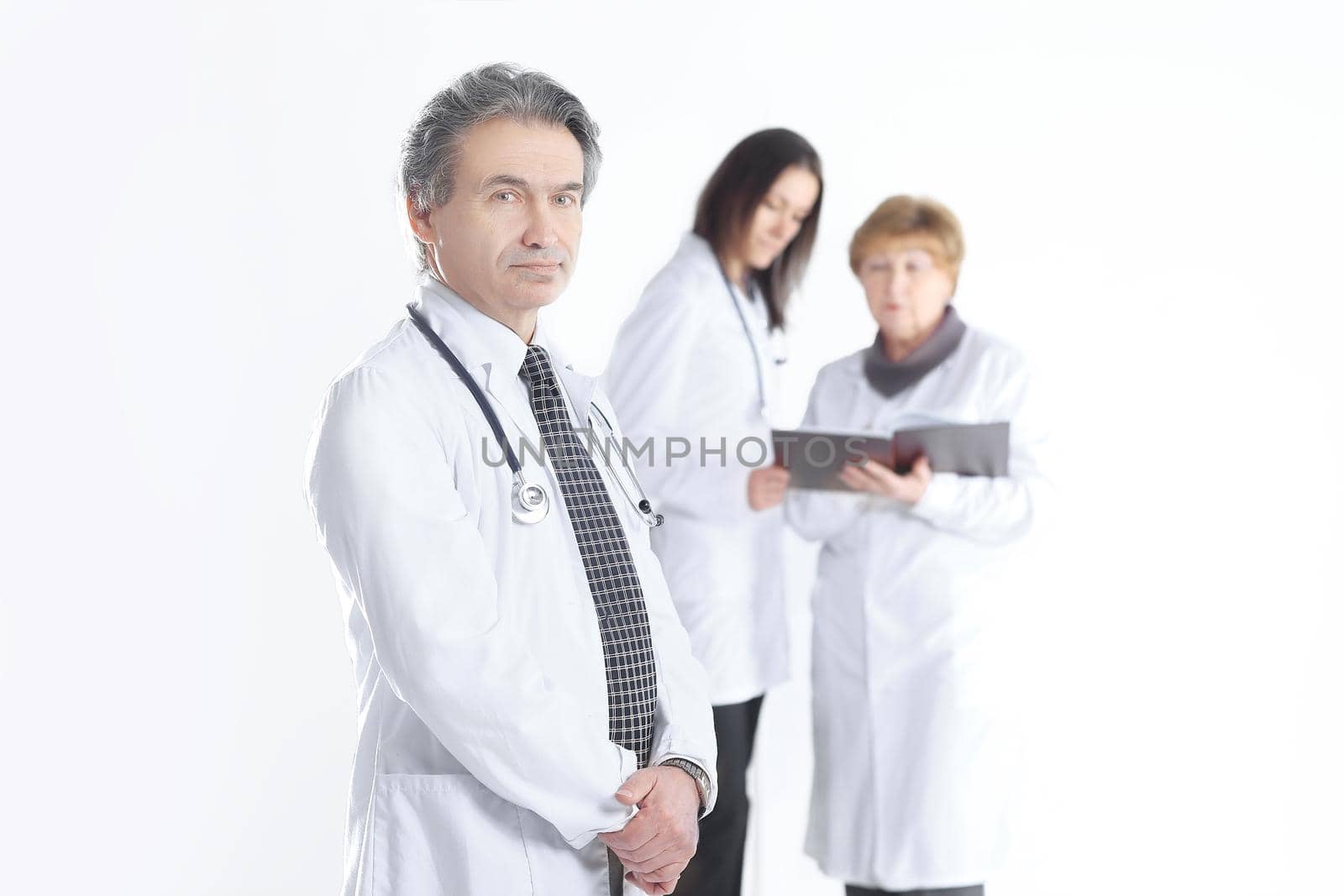 serious therapist doctor on blurred background of colleagues.